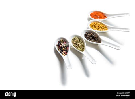 Close-up view of assorted dried aromatic spices in ceramic spoons ...