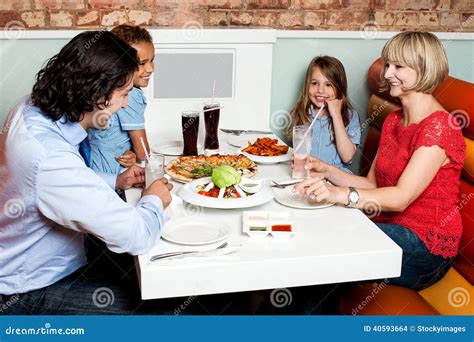 Happy Family Enjoying Dinner Stock Photo - Image of food, couple: 40593664