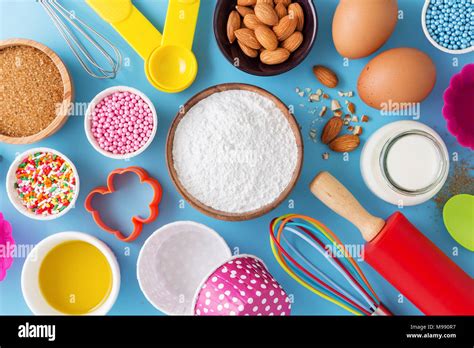 Baking ingredients and utensils on blue background Stock Photo - Alamy