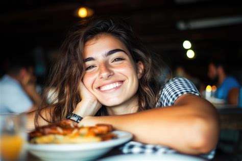 Smiling Woman with Long Hair Enjoying a Meal in a Cozy Restaurant ...