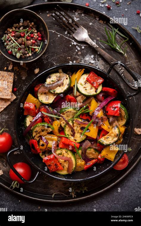 Roasted cooked assorted vegetables with herbs and spices Stock Photo ...